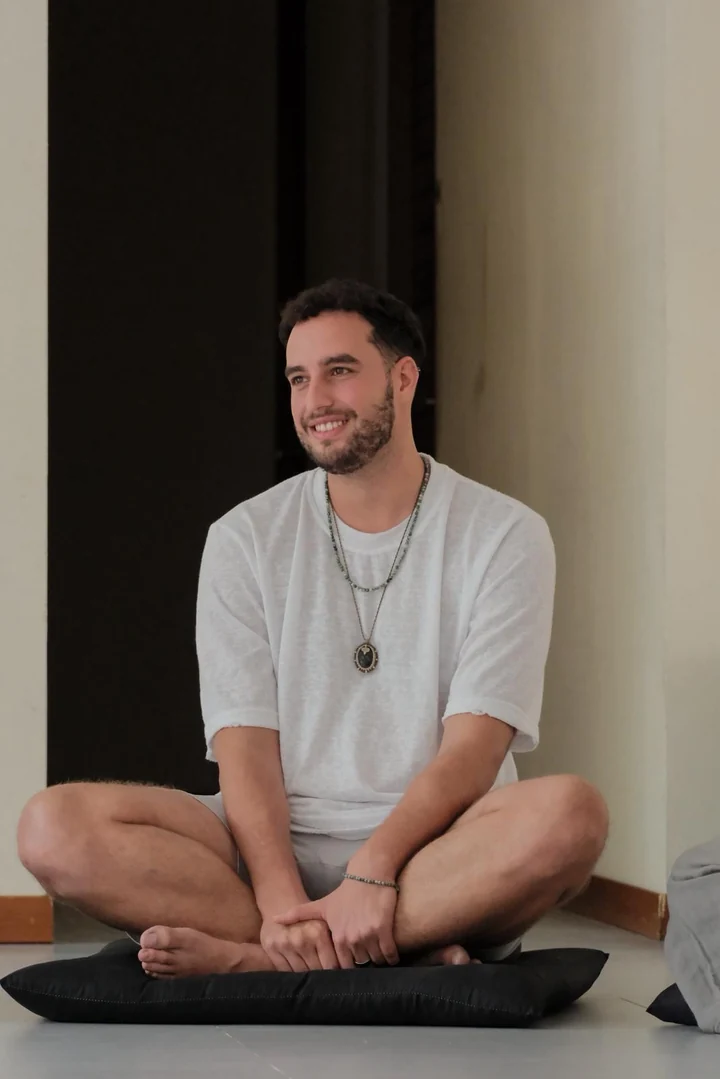 Ron, founder of RBR, sitting cross legged and smiling